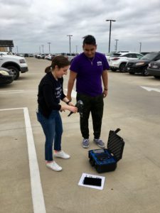 Student Isaac Percastegui stands alongside Jayne Orenstein in the Frog Alley Parking Garage to unpack and set up the drone. 