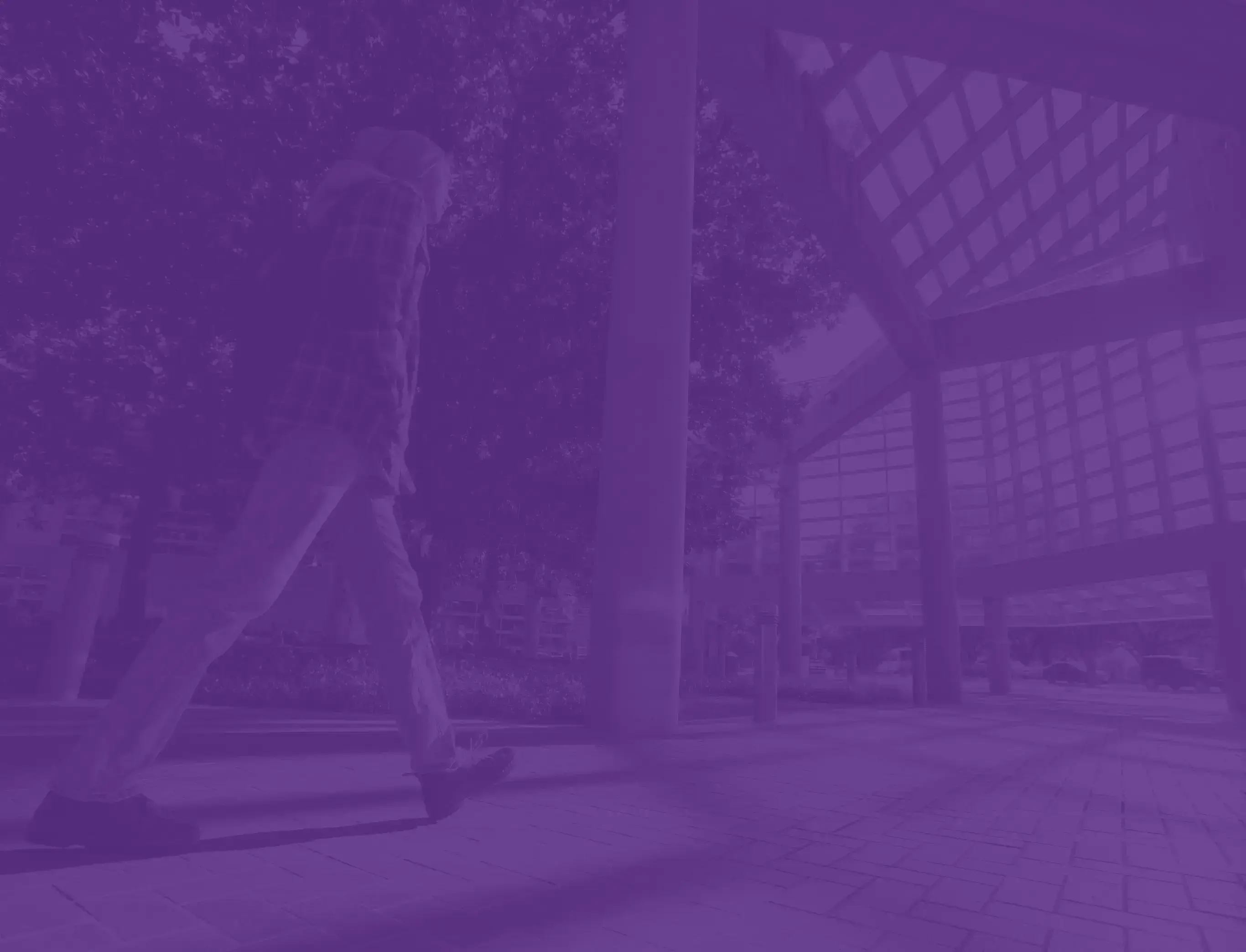 background image of a T.C.U. student walking on campus with a T.C.U. purple overlay