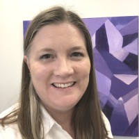 Woman standing in front of a painting.