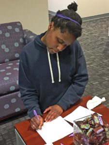 student writing a thank-you note to her scholarship donor