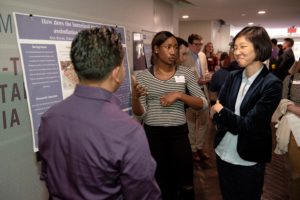Two students present their project to Communication Studies Professor Jackie Zhuang.
