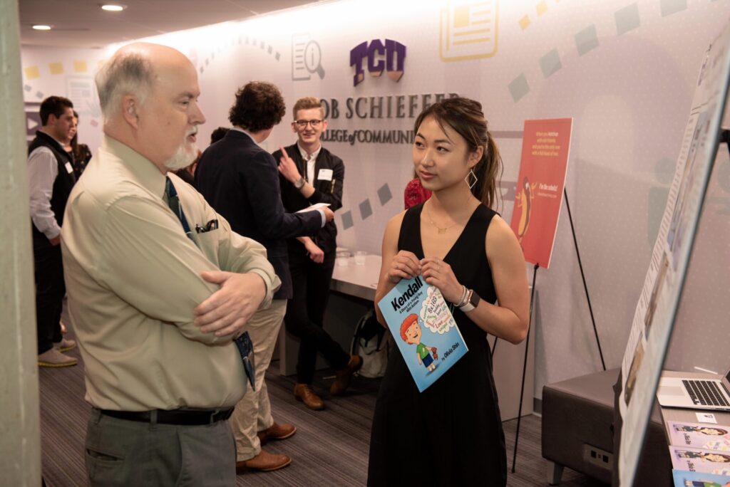 A Schieffer College student visits with a Communication Studies professor.
